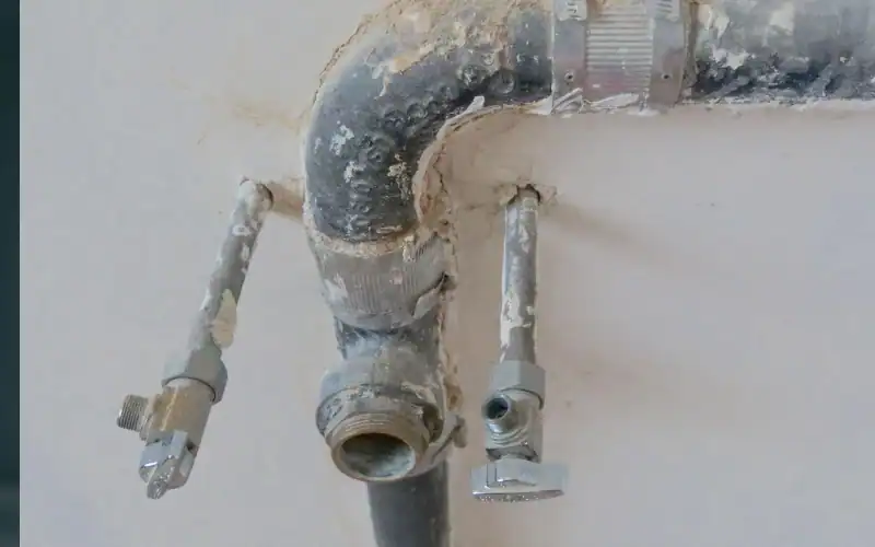 Exposed metal pipes mounted on a wall