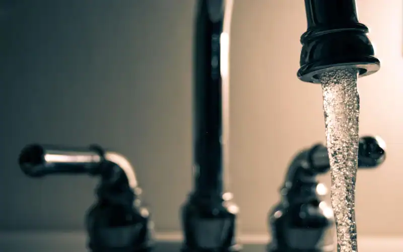 Water flowing from a stainless steel faucet