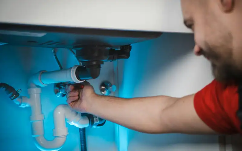 a man repiping a house to prevent frequent plumbing issues