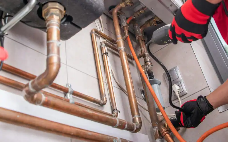 a professional plumber engaged in repiping a home's plumbing system