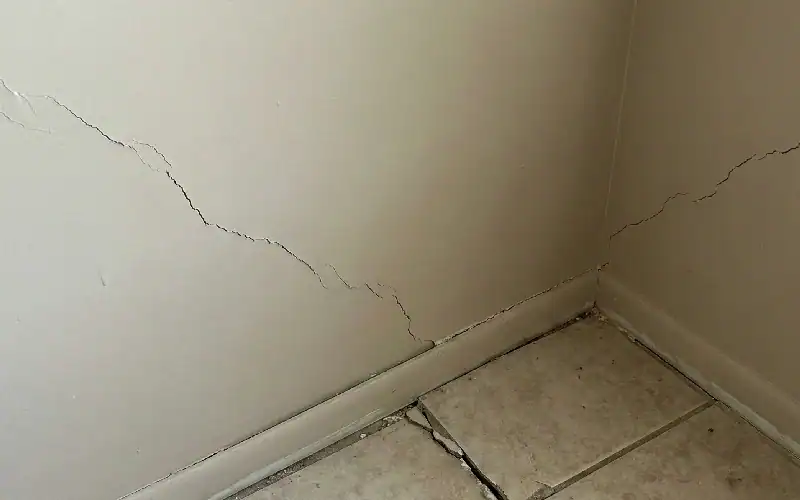 cracked wall and damaged tiles