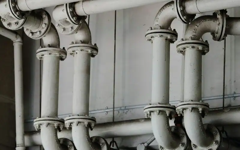 grayscale photography of metal pipes
