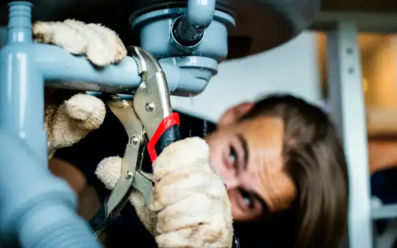 plumber fixing pipe leak